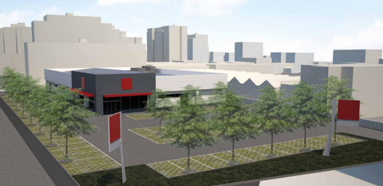 Un supermercato e un parcheggio nel quartiere Prealpi